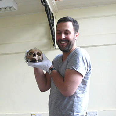 Paul Davies holding the skull of the Ivory Bangle Lady