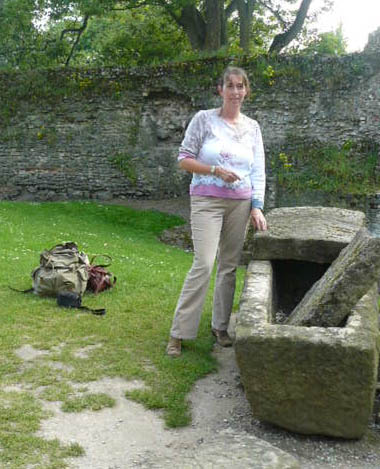 Dr Stephany Leach stood next to a sarcophagus